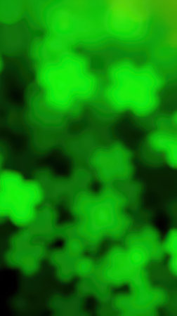 Bright green foliage fills the frame with soft bokeh effect showcasing natures vibrant colors in a lush environmentの素材