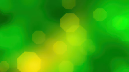 Vibrant green and yellow bokeh lights create a lively and vibrant atmosphere in this abstract backgroundの素材