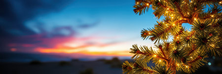 Twinkling lights on a pine tree against a vibrant sunset sky near a wintery landscapeの素材