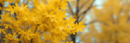 Bright yellow autumn leaves flutter gently in the breeze during a tranquil fall day in a serene forest settingの素材