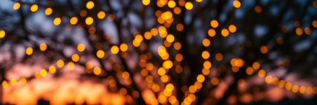Warmly lit tree during sunset creates a cozy atmosphere in the evening skyfilled with colorsの素材
