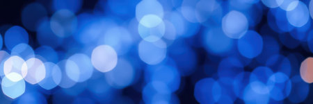 Bright blue bokeh lights create a dreamy atmosphere in a nighttime urban settingの素材