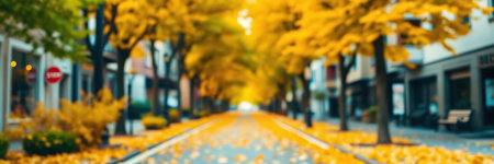 Vibrant autumn streets lined with golden leaves in a tranquil city setting during a sunny dayの素材