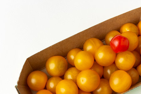 Colorful cherry small tomatoes in craft box. Organic ingredients for salad and healthy eating. Top...