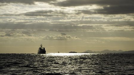 Motor yacht Teddy advancing on a roughening late afternoon sea at Cap Ferratの写真素材