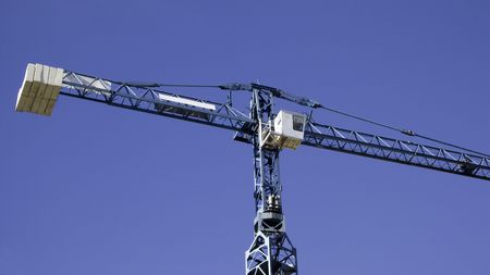 Top part of a Construction  crane against an azur blue skyの写真素材