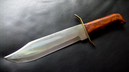 Original captain james bowie knife with wood handle on leather backgroundの写真素材