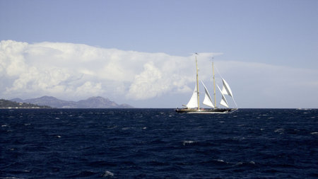 Classic sailing yacht on a wide expanse of sea in a gale