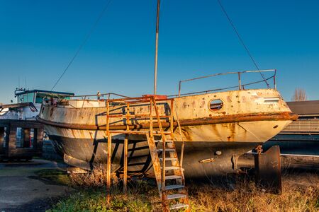Old ship wreck on the shore in the harbor of the city Deventer, Overijssel the Netherlandsの写真素材
