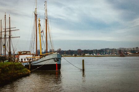 City view and skyline with beautiful medieval houses and ships at the Hanseatic city Kampen and the river "the IJssel", province Overijssel the Netherlandsの写真素材