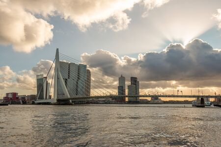 Cityscape in Rotterdam near the river Maas in wintertime and beautiful clouds and with modern skyscrapers and beautiful buildings at the famous Erasmus bridgeの写真素材