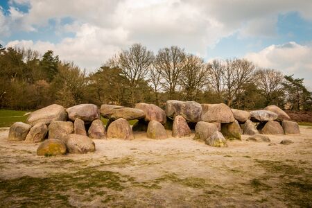 A hunebed in the Holtingerveld near Havelte in the province of Drenthe, ancient prehistoric stones from the ice age and later used as a grave by the Hunen, people also from ancient timesの写真素材