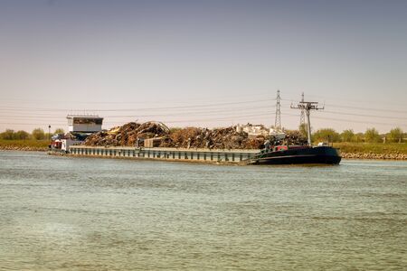 Transport ship with metal scrap on the river IJssel in the province of Overijssel in the Netherlandsの写真素材