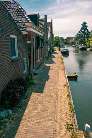 Hindeloopen a beautiful town in the Netherlands on the IJsselmeer, province of Friesland with canal boats and a harborの写真素材