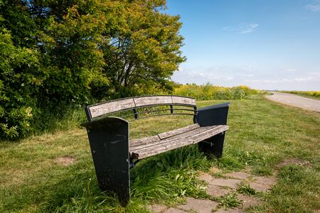 small bench to rest on the side of the road in the Netherlands, province Friesland region Gaasterlandの写真素材