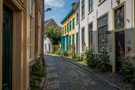 Beautiful narrow streets in the center of the Hanseatic city of Zutphen with beautiful colored houses and flowers on the side of the roadのeditorial素材