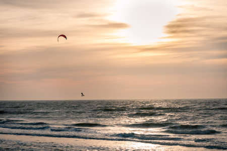 Kite surfer in winter at sunset on the North Sea at the Wadden island of Texelの写真素材