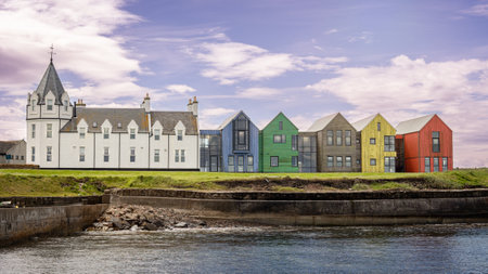 The harbor at John O' Groats and the colored houses at one of the northernmost points of Scotland if you arrive via the North Coast 500 route.の写真素材