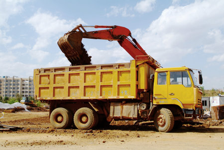 Excavator on a construction site. excavator bucket with soil earth works.の写真素材
