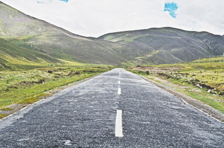 Straight road to the mountainsの写真素材