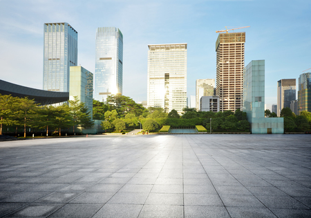 empty city square with skycrapers and treesの写真素材