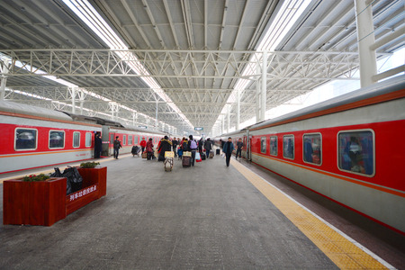 Train on a platform at the Central Railway station of Xian, China. THe most populated railway station in Xian, China.のeditorial素材