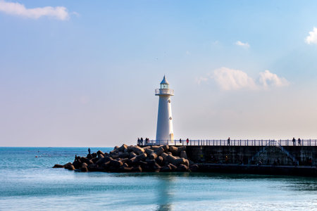 a landscape with a blue sky and a lighthouse
