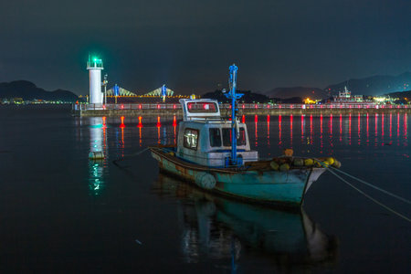 a view with a lighthouse and a bridgeの写真素材