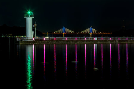 a view with a lighthouse and a bridgeの写真素材