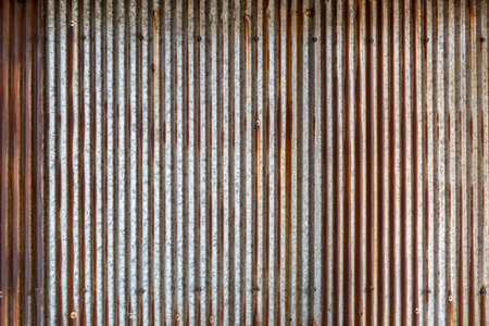 Rusted, galvanized, corrugated iron siding, vintage background.