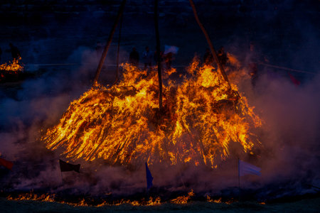 Large ritual bonfire burning in Korean traditional cultural festival symbolizing folk heritage and...