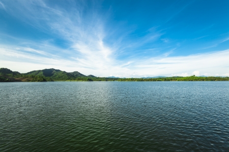 island with green trees under blue skyの写真素材