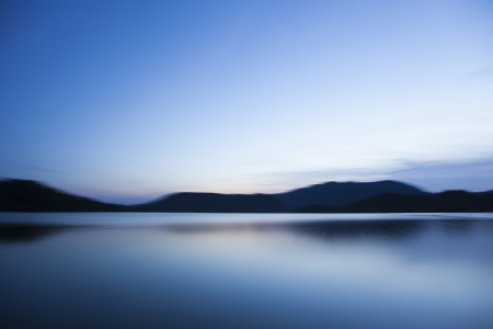 lake reflection of mountains at night with twilightの写真素材