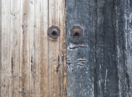 an old weathered wooden door handle with knocker in south east Chinaの写真素材