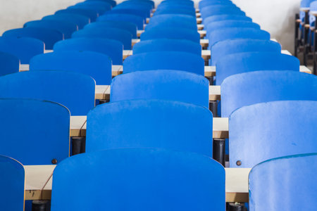 blue chairs and tables in a classroom