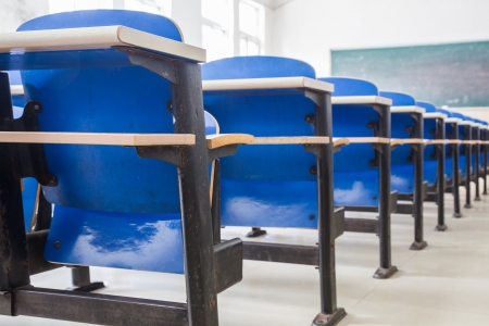 blue chairs and tables in a classroomの写真素材