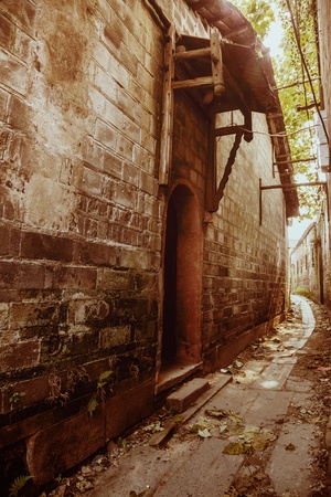 aged alley with stone wallの写真素材