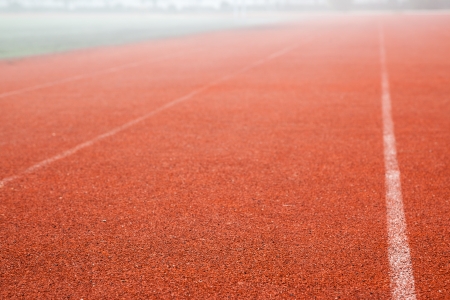 red running track field with white linesの写真素材