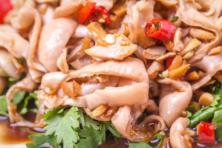 pig intestines stir fried with vegetables, chili peppers, a popular traditional chinese dishの写真素材
