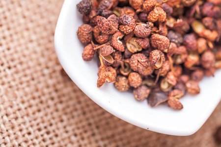 Chinese prickly ash on china dish with flax backgroundの写真素材