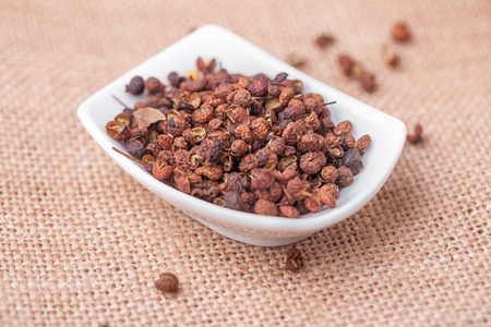 Chinese prickly ash on china dish with flax backgroundの写真素材
