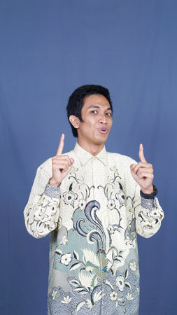 asian man thinking and get some idea with batik clothesの写真素材