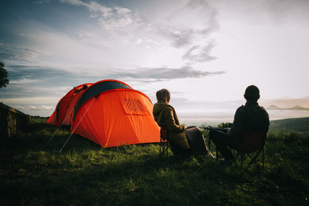 Asian couple camping with sunrise view in mountainの写真素材