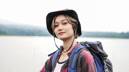 young Asian female prepare for hipster hiking
