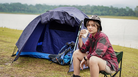 young Asian female drink coffee in chairの写真素材