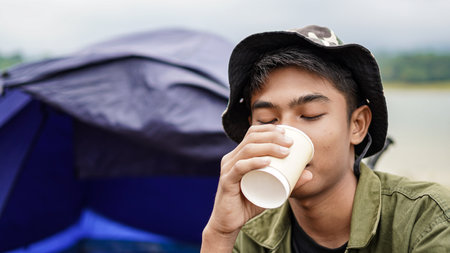 traveller man drink coffee at campの写真素材