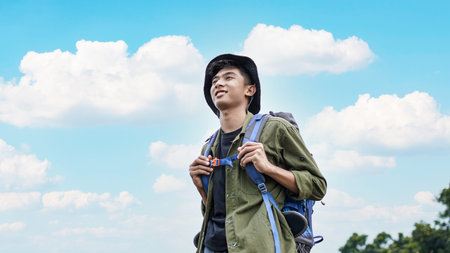 young Asian man traveler with backpack in reservoir