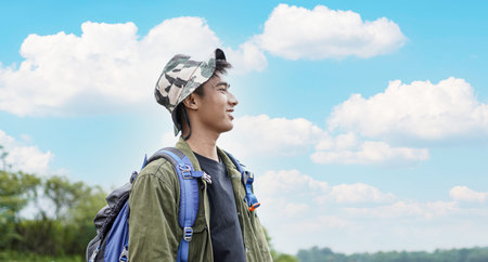 young Asian man traveler with backpack in reservoir