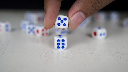 Dice arranged by hand on topの写真素材