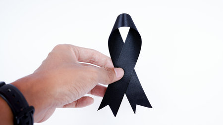 Black awareness ribbon isolated on white background. Black ribbon icon for pray, mourning symbol,の写真素材